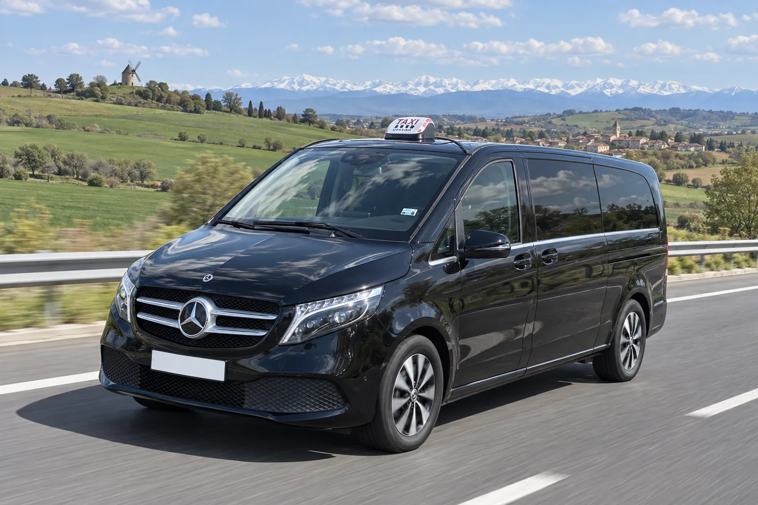 La Classe V de VK Taxi sur l’autoroute à travers les champs du Lauraguais, les Pyrénées enneigées à l’horizon